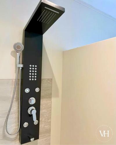 a shower in a bathroom with a black wall at The Triplex at Villa Horizon - Three Private Suites in Rodney Bay Village