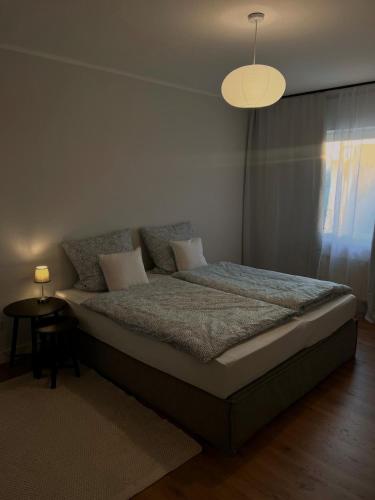 a bedroom with a bed with a lamp and a table at Fewo Steckinghof in Coesfeld