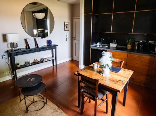 a dining room with a table and a mirror at Florence in the Window in Florence