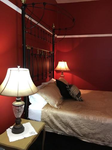 a bedroom with a bed with two lamps on tables at Oakdene Heritage Accommodation in Saint Marys