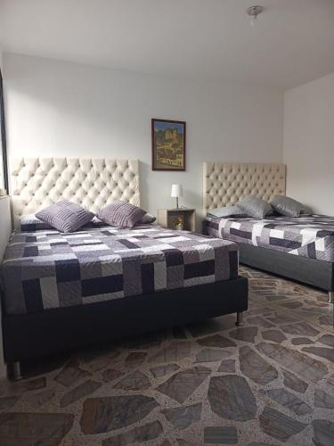 a bedroom with two beds in a room at Casa Manila Medellin in Medellín