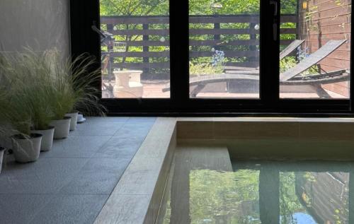 an open door to a patio with potted plants at Yangpyeong Tov Master Class in Sŏch'anam-ni