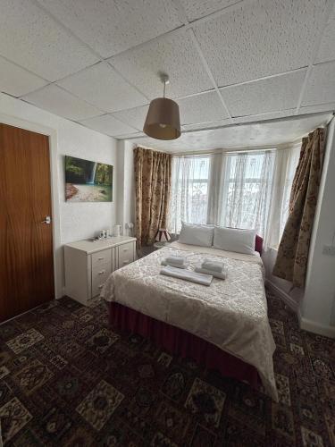 a bedroom with a large bed in a room at Pleasure Beach Hotel by OYO in Blackpool