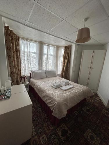a bedroom with a bed and a window at RideSide Hotel in Blackpool