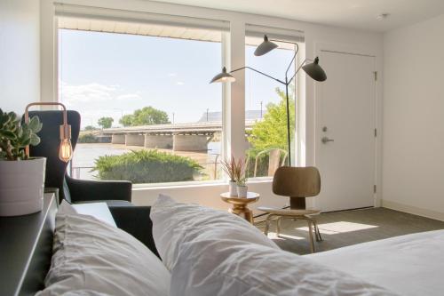 ein Schlafzimmer mit einem Sofa und einem großen Fenster in der Unterkunft Skyfall Guestrooms in Green River