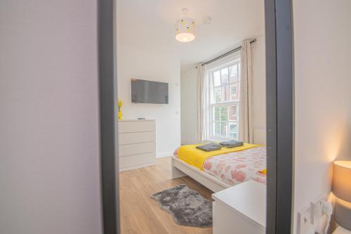a small bedroom with a bed and a window at The Oxford Rooms in Southampton
