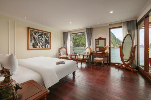a bedroom with a large bed and a large window at Emperor Cruises Legacy Ha Long in Ha Long
