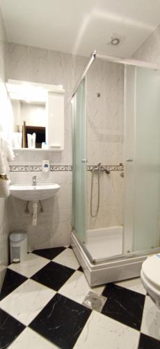 a bathroom with a shower and a sink and a toilet at Hotel Vojvodina in Novi Sad