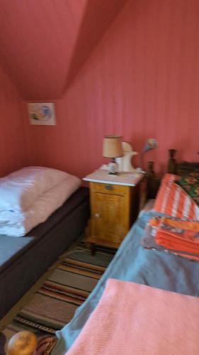a bedroom with a bed and a table with a lamp at Solvoll Sør-Grunnfjord 