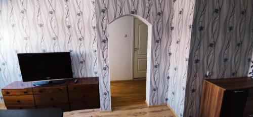 a room with a mirror and a television on a dresser at Särevere apartment in Särevere Asundus