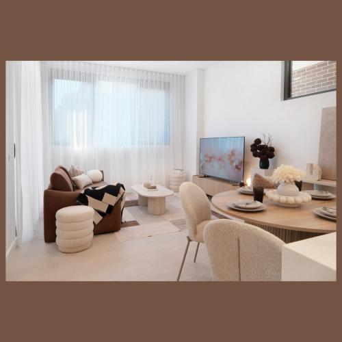 a living room with a couch and a table at 'Amber' 1 bedroom apt in Burwood with free parking in Sydney