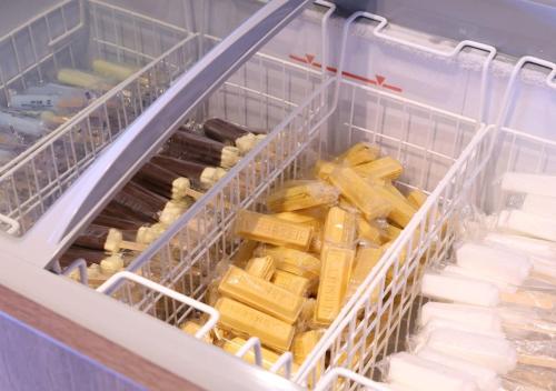 a refrigerator filled with lots of different types of cheese at Dormy Inn Premium Hakata Canal City Mae in Fukuoka