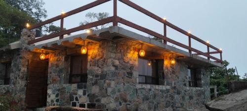 a stone house with lights on top of it at Nasaka jacala in Tzicuilán
