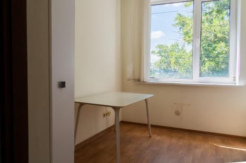 an empty room with a table and a window at Sicheslav Hostel in Dnipro