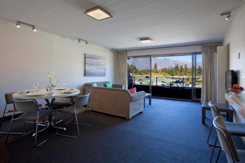 a living room with a table and a couch at The Lofts Apartments in Queenstown