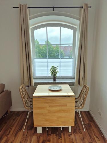 a room with a table and a large window at Studio 3 - Apartments am Schloss in Oberschleißheim