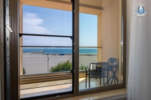 a room with a window with a view of the ocean at Daria Boutique Hotel in Eforie Sud
