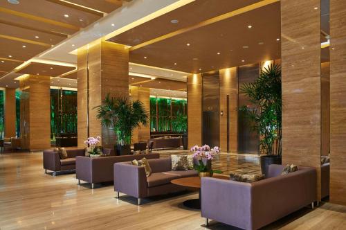 a lobby with couches and tables in a building at VE Hotel & Residence in Kuala Lumpur