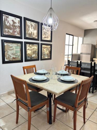 a dining room with a table and chairs at Acogedor apartamento minimalista Mai in Puerto Vallarta