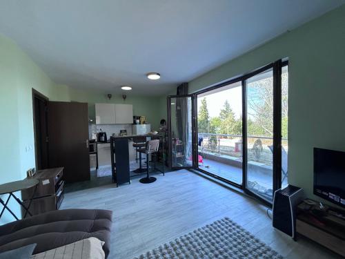 a living room with a large sliding glass door at морско бижу in Byala