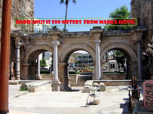 a building with arches with a sign that reads madinimum its meters at Marka Hotel in Antalya