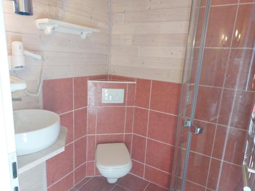 a bathroom with a shower and a toilet and a sink at Hotel Kapelle Bed & Breakfast in Bad Liebenstein