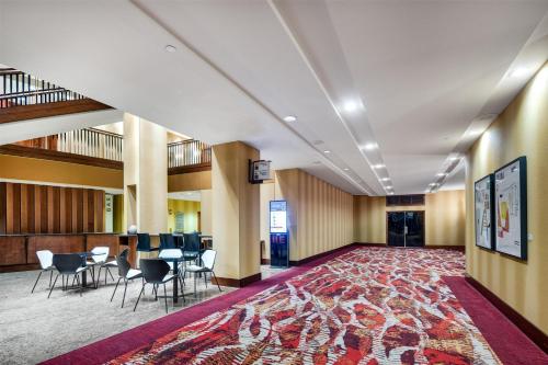 a large lobby with chairs and tables and a rug at Hilton Lac-Leamy in Gatineau
