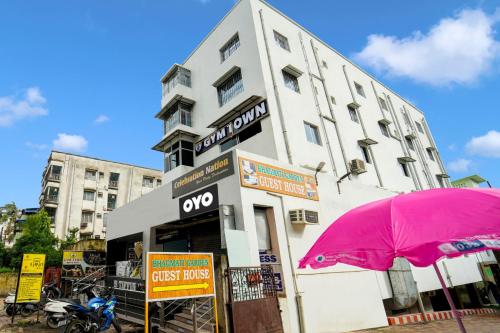 a building with a pink umbrella in front of it at HOTEL O BHAGMATI GARDEN GUEST HOUSE in Dhanbād