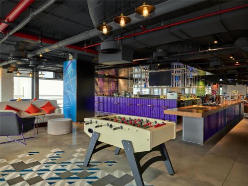 a room with a foosball table and a bar at Tru by Hilton Bac Giang City Centre in Bắc Giang