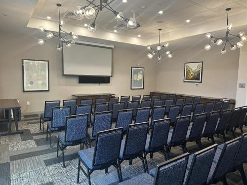 a lecture room with chairs and a projection screen at DoubleTree by Hilton Greenville Woodruff Road in Greenville