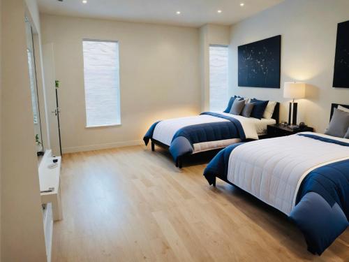 a large bedroom with two beds and a window at Hollywood Boutique Residences with Free Parking in Los Angeles