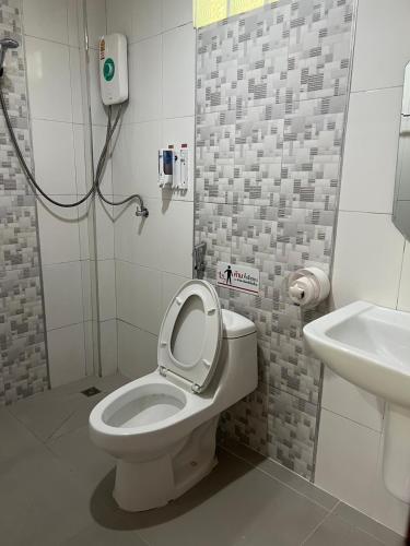 a bathroom with a toilet and a sink at Thebedkolok resort in Sungai Kolok