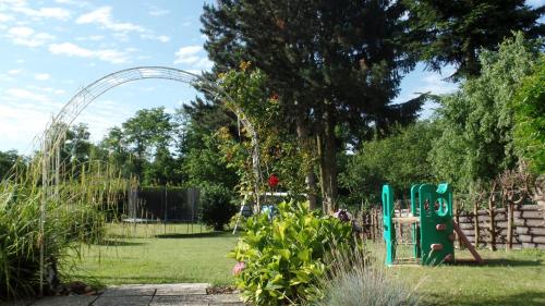a playground in a garden with an arch at Haus Floresa in Lutzmannsburg
