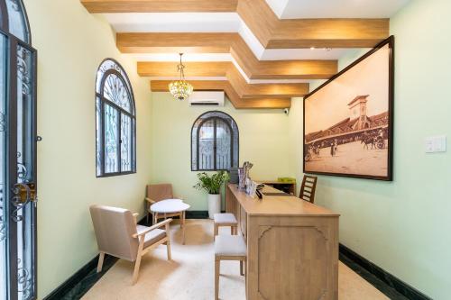 an office with a desk and chairs in a room at Nicecy Hotel - Trương Quyền in Ho Chi Minh City