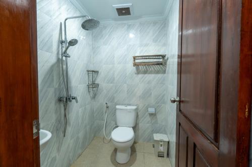 a bathroom with a toilet and a shower at Adis Villa, Cozy Private Stay with Pool , near ubud & sanur in Darmasaba
