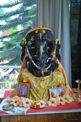 a cake with a statue on top of a table at Hotel Snow View in Daringbadi