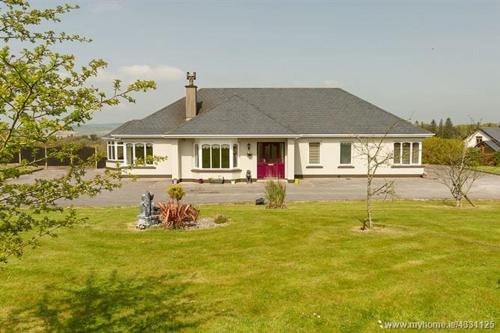a white house with a red door in a yard at Ardsallagh, countryside retreat outside Youghal in Youghal