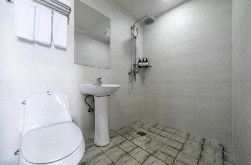 ein weißes Badezimmer mit Toilette und Waschbecken in der Unterkunft Jeju Pure Stay Ocean in Jeju-do