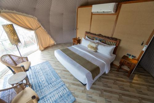 a bedroom with a large bed in a tent at La Joya Farm Resort & Spa in Aloguinsan