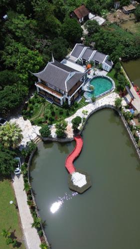 an aerial view of a house in a lake at Happy Tam Coc Ecolodge in Ninh Binh