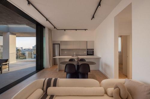 a living room with a couch and a table at YAMAS Urban Living SEQUOIA Residence in Limassol