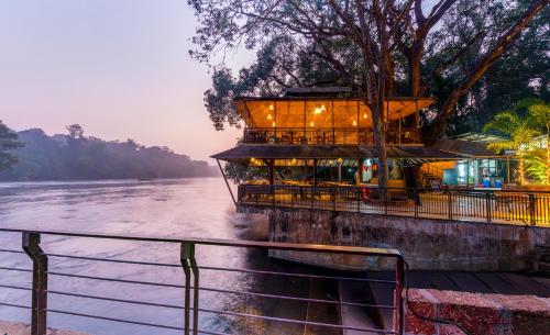 a building on the banks of a river at Silverbill Resorts-Redefining 5-Star Luxury in Dandeli in Ganeshgudi