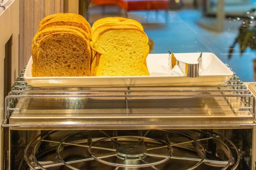two slices of bread sitting on top of an oven at Madi city Hotel in LʼAquila