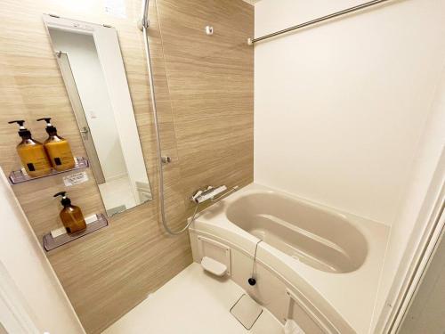 a bathroom with a toilet and a sink and a shower at OPEN! TOKYO Kitasenju A Newly built stylish room! in Tokyo