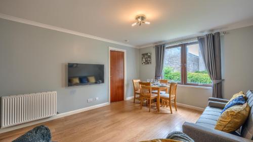 a living room with a couch and a table at Sharon Apartments Back Hilton in Aberdeen