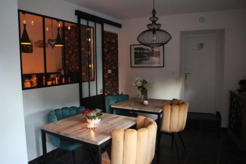 a dining room with a wooden table and chairs at La Catiniere in Arnage