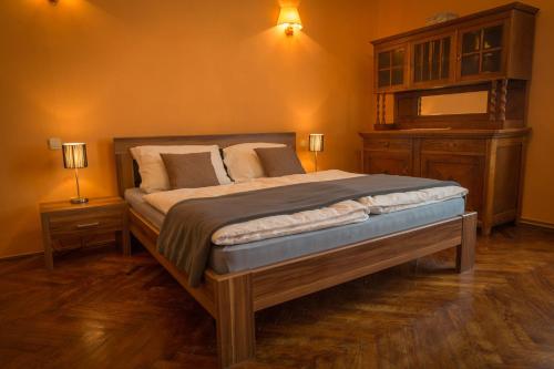 a bedroom with a large bed with two lamps on the wall at Apartment Bozic in Lovran