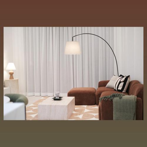 a living room with a couch and a table at 'Arch' 2 Bedroom Apt in the heart of Burwood, near everything in Sydney