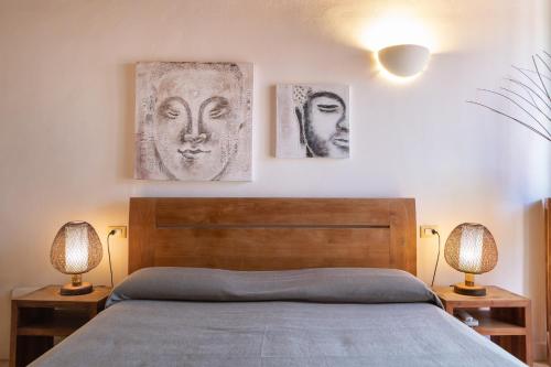 a bedroom with a bed and two pictures on the wall at Hotel Al Convento in Vezzano Ligure