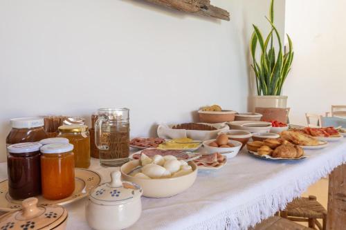 a table with many different types of food on it at B&B Agricola Bellisario Ospitalità Rurale, Alimini Otranto in Conca Specchiulla